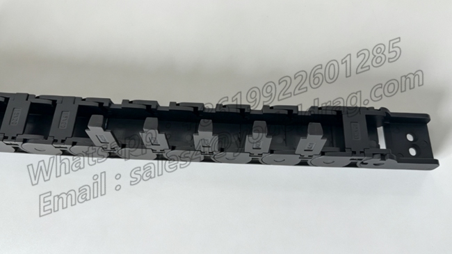 Side-opening latches snapped open on a semi-enclosed PA66 small drag chain for easy cable installation