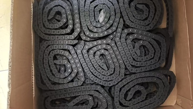 Neatly coiled PA66 miniature cable carriers packed in a heavy-duty carton box for export shipment