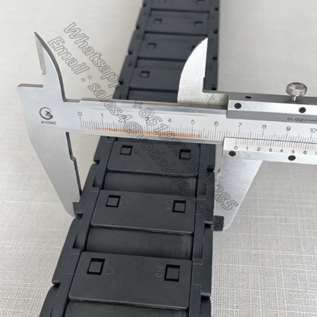 Precision width dimension measurement for enclosed CNC cable chain machinery carrier.